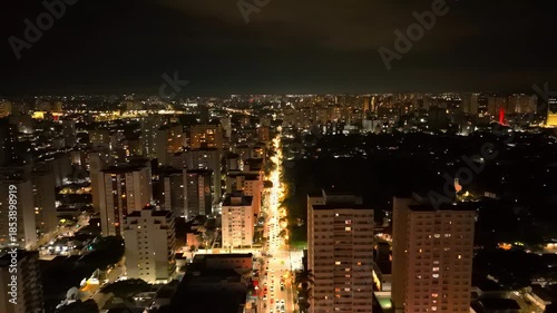 night aerial view of downtown Sao Jose dos Campos with bright lights over a busy street 