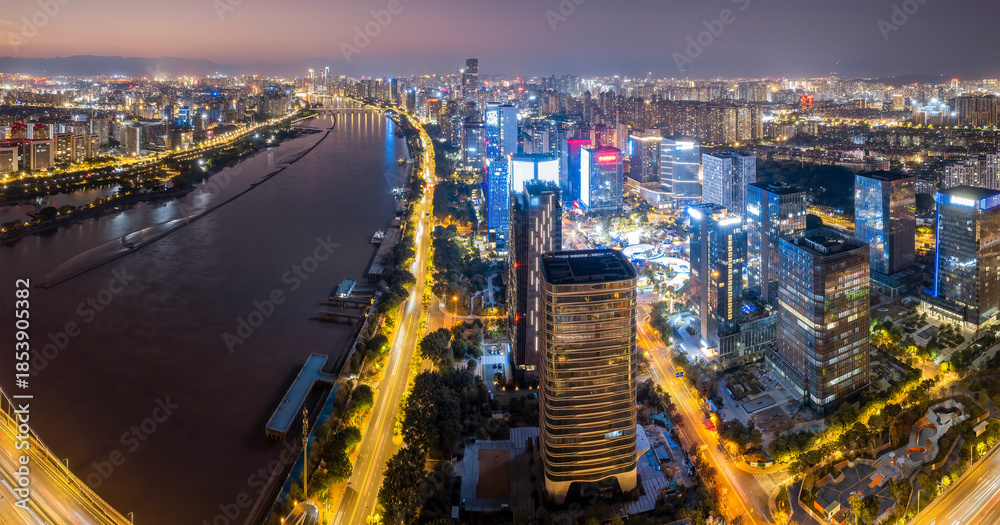 Obraz premium Night View of Modern Urban Skyscrapers Along River