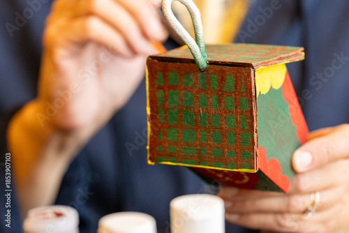 Canvas Print Shallow DOF image of woman painting a small birdhouse arts and crafts concept