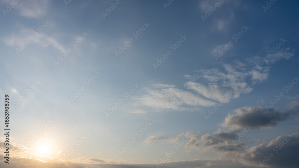 Fototapeta premium Sunrise with Fluffy Clouds in Clear Blue Sky