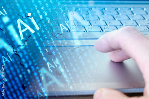 Close-up of gray keyboard and hand over touchpad.