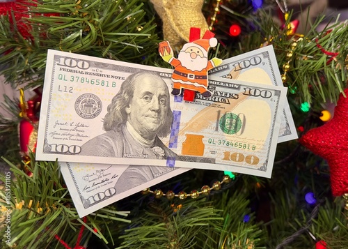 christmas One Hundred dollar bills. Money on Christmas tree.Christmas luck and wealth. Christmas gift concept.