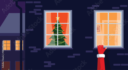 Santas hand reaching for a dark building window that reveals a brightly lit room with a decorated Christmas tree inside at night.