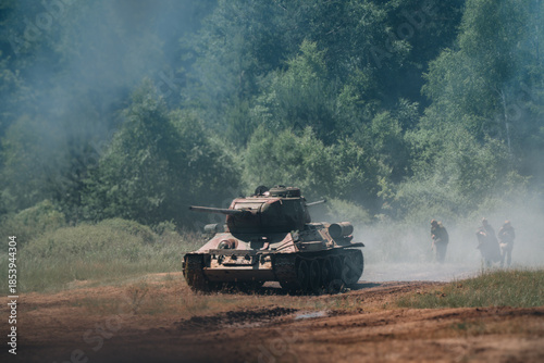 Quadro em tela Soviet T-34/85 tank drives through forest battlefield, iconic machine of World War II, dynamic military equipment