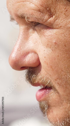 Summer heat, exhausted man wipes sweat from his face
