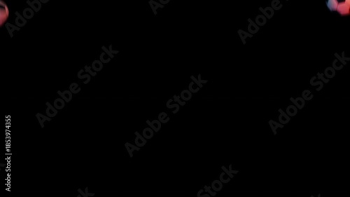 Dirty worn soccer balls falling with red and blue neon lighting. Moody sports transition with alpha channel.