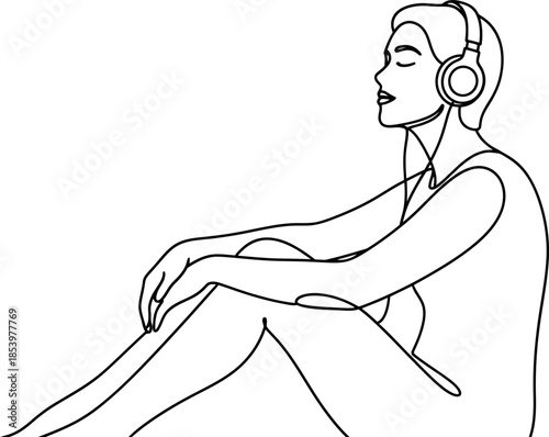Woman sitting and listening to music on headphones in a relaxed pose