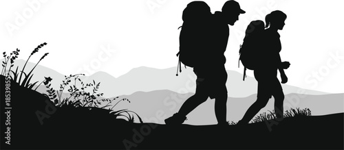 Outdoor Hiking Silhouette Featuring a Male and Female Backpacker Trekking Through Scenic Mountainous Wilderness Terrain