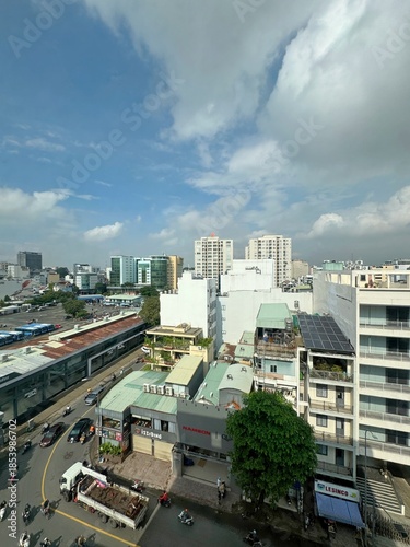 Rooftop view of the Ho Chi Minh City skyline featuring dense urban development, solar-equipped low-rise buildings, and modern skyscrapers, December 23, 2025. 