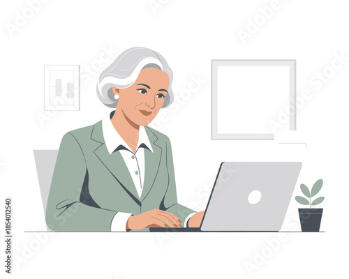 Mature businesswoman working on laptop at office desk