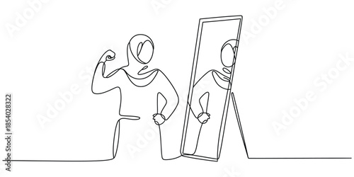 Empowered woman in hijab flexing muscles, observing her true reflection in a mirror