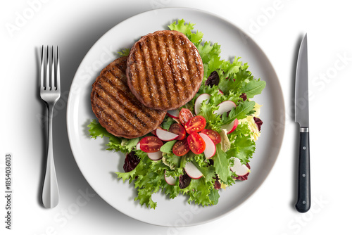 Two hamburgers with mixed salad on a round white plate