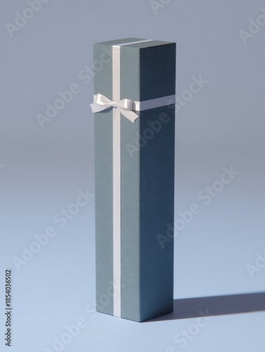 Elegant tall gift box with white ribbon on soft blue background