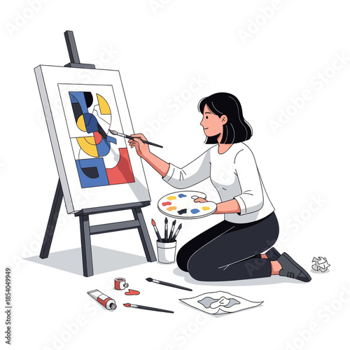 Creative female artist painting abstract artwork on canvas in a modern studio space