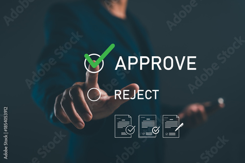 A person in a dark setting is pressing a button labeled 