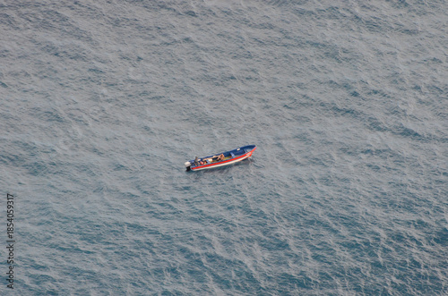 Fishing boat on open ocean, highlighting solitude and adventure