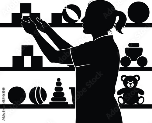 Black silhouette of female worker arranging toys on shelves in a store or playroom