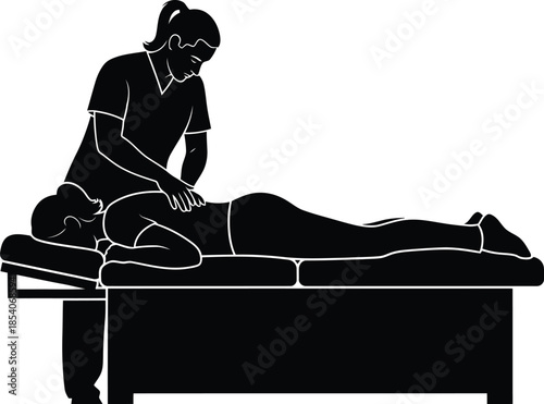 A massage therapist provides professional bodywork to a client lying on a table in a wellness setting