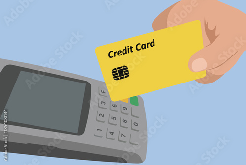 Hand holding yellow credit card near payment terminal