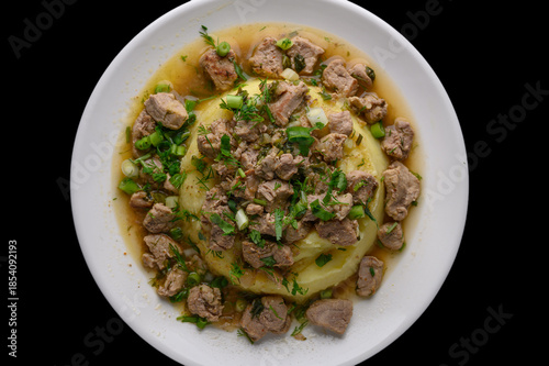 Creamy Mashed Potatoes with Meat on Black