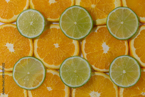 Lime Wedges on Orange Slices Background