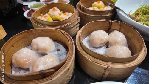 Assorted steamed dim sum in bamboo baskets
