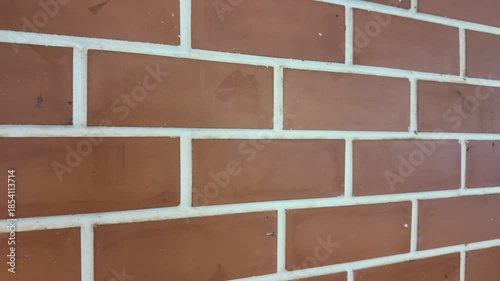 Red brick wall with white mortar lines
