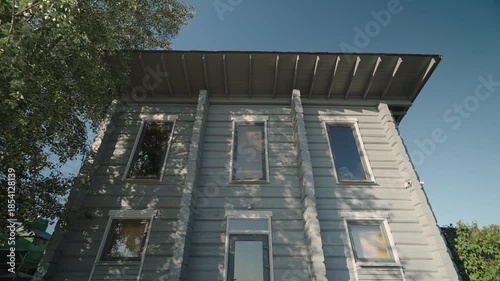Modern rustic two-storey wooden house. Camera in motion