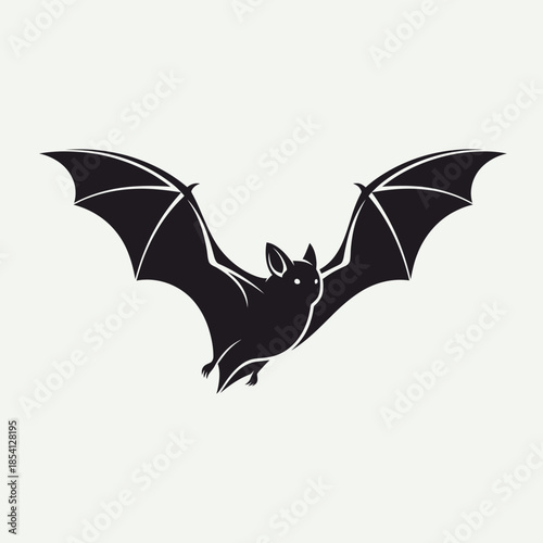 Silhouette of a bat with wings spread wide in flight.