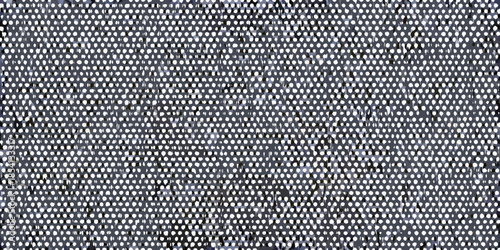 Close up of a textured gray fabric with a repeating dotted pattern