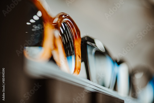 Closeup of sunglasses in store. Fashion eyewear products presented on elevated surface