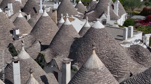 Traditional Trulli Rooftops, Aerial Shot of Unique Conical Roofed Houses of Alberobello in Puglia, Italy. Sunny Day.