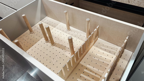 Photography Clean empty kitchen drawer with light wood pegboard