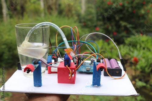 Prototype of mini electronic project comprising of submersible pump and other sensor modules connected to micro controller using jumper cables