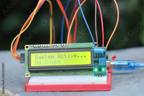 LCD module or liquid crystal display connected to breadboard and sensor module showing some words on the display board controlled by controller