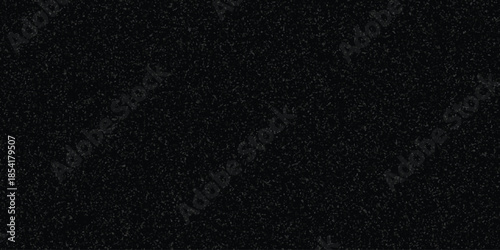 Black granular texture background with a dense pattern of tiny grey particles for abstract design and visual overlays