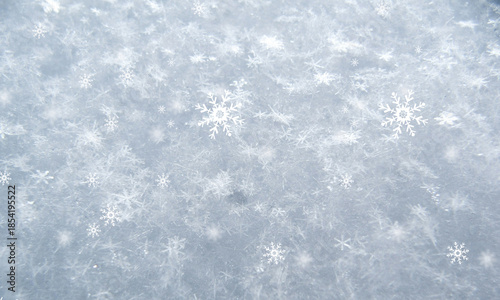 Beautiful pattern of white snowflakes falling gently onto a textured icy surface on transparent background