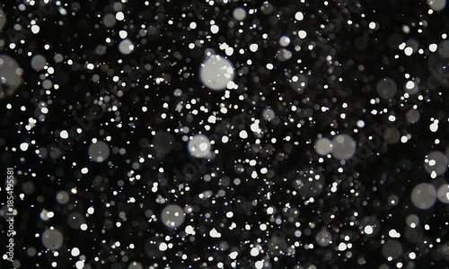 Heavy snowfall abstract background with bright white bokeh circles on a dark night on transparent background