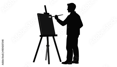 Silhouette of an artist painting on a canvas with a brush on an easel.