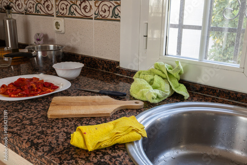 Messy kitchen counter preparing roasted red peppers