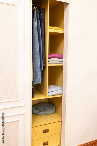 Organized closet interior showing clothes storage and drawers
