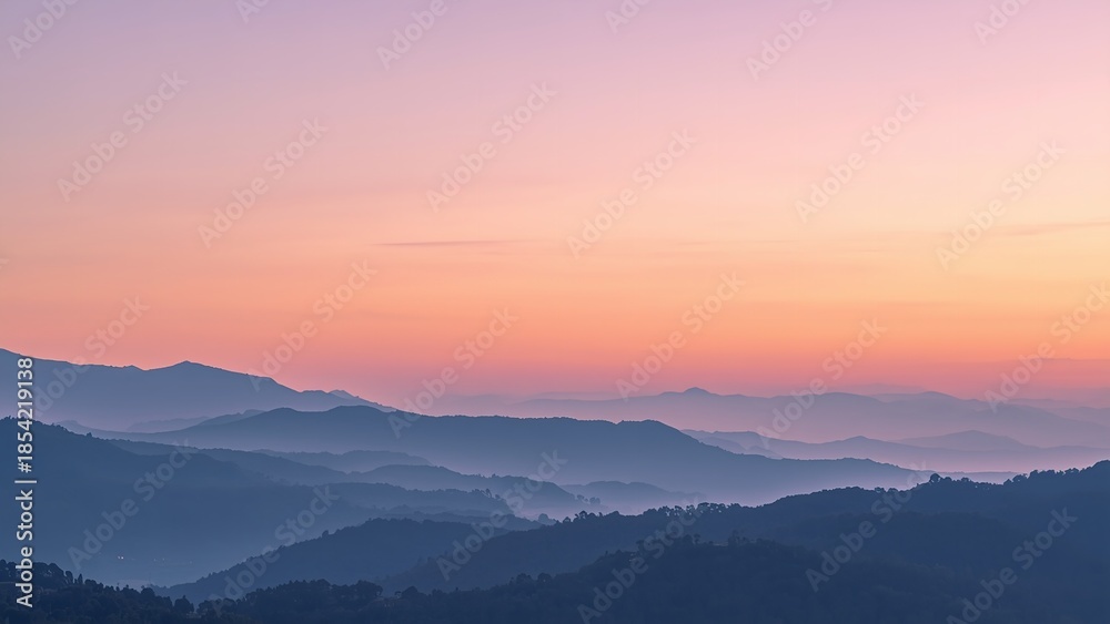 Obraz premium A serene mountain landscape at sunset with rolling hills and a vibrant sky