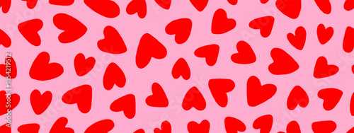 Seamless background pattern with messy red hearts in primitive hand drawn style on pink backdrop, for holiday wrapping paper and textile design, vector illustration.