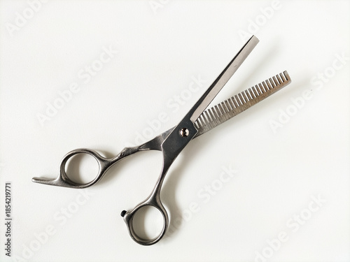 Fotografie Stainless steel hair thinning scissors featuring one straight blade and one toothed blade