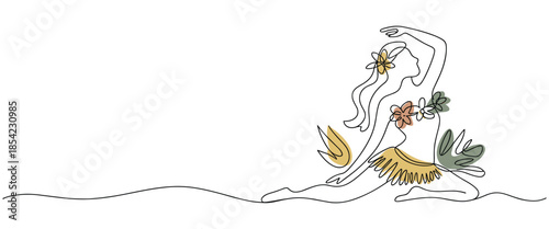 Woman in a flowing floral dress sitting in a yoga pose with flowers in her hair