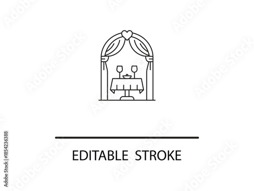 Romantic dinner setup with wine glasses and heart shaped decoration.