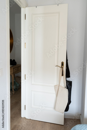 White door opening into a home hallway