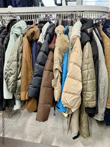 Display Of Muted Winter Outerwear, Rack Featuring Nylon And Down Insulated Garments For Winter Seasons, Exhibition Of Various Muted Coats And Jackets With Quilted Textures And Padding