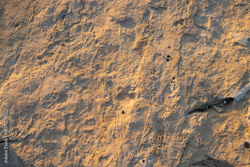 Close up texture of natural yellow limestone rock surface