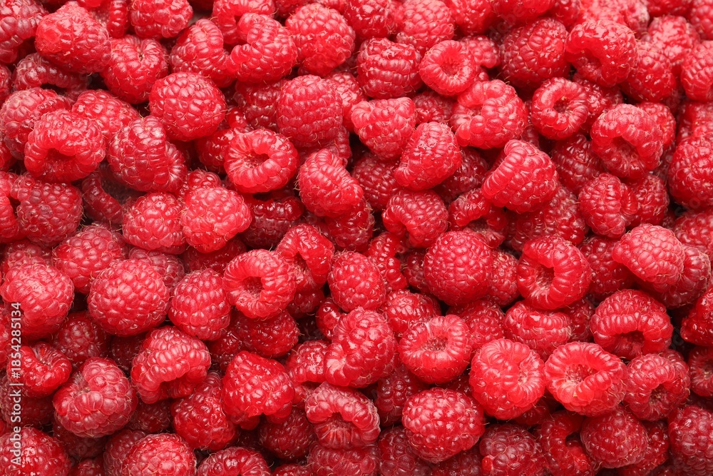 Fototapeta premium Fresh ripe raspberries as background, top view